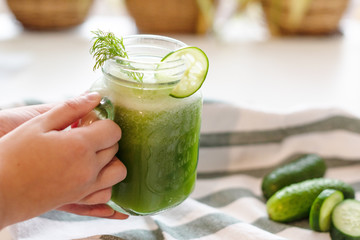 the process of making fresh juice or cucumber smoothies, detox smoothies and juices, weight loss diet
