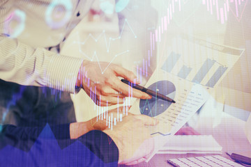 Obraz na płótnie Canvas Financial trading graph double exposure with man desktop background.