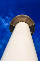 Lighthouse on the blue sky background, view from below
