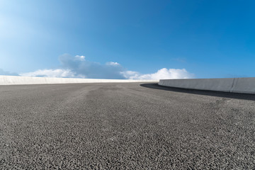 Skyline of Asphalt Pavement and Blue Sky and White Cloud