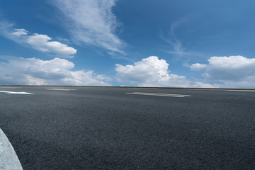 Skyline of Asphalt Pavement and Blue Sky and White Cloud