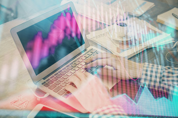 Double exposure of forex graph with man working on computer on background. Concept of market analysis.