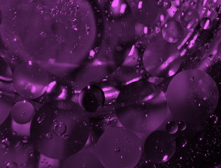 Oil bubbles in water closeup.