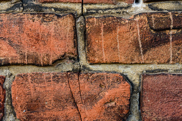 Old red brick wall with crack
