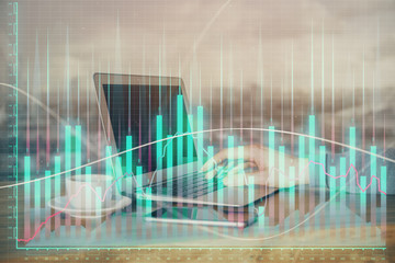 Double exposure of stock market graph with man working on laptop on background. Concept of financial analysis.