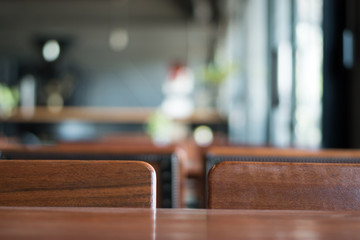 An old wooden table in a coffee shop. Blur with copy space.