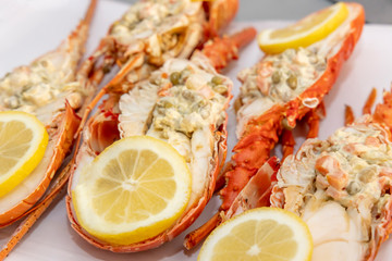 Spiky Lobster. Half lobster stuffed with salad and lemon wedges.
