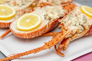 Spiky Lobster. Half lobster stuffed with salad and lemon wedges.