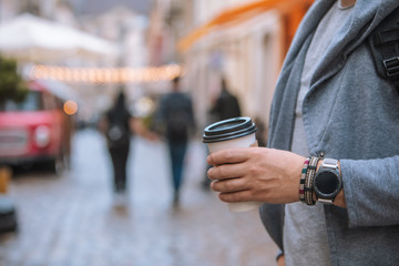 man hand close up holding disposable coffee cup