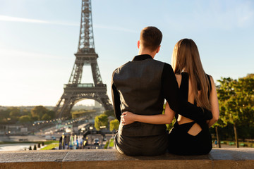 Couple looking at Eiffel tower, romantic date in Paris. Honeymoon, travel in France