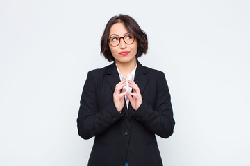 young businesswoman scheming and conspiring, thinking devious tricks and cheats, cunning and...