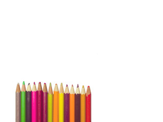 various colors of pencils on a white background, copy space