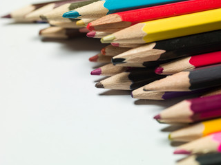 various colors of pencils on a white background, copy space