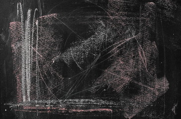 Black chalkboard, blackboard with chalk stains and scribbles background and texture