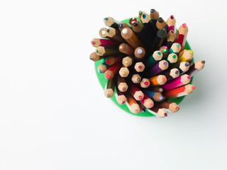 various colors of pencils on a white background, copy space