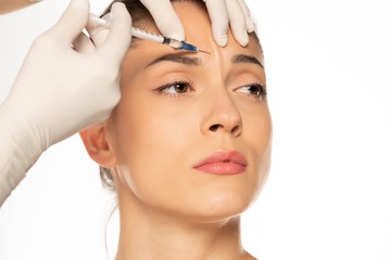 Portrait of a young beautiful woman on a face filler injection procedure