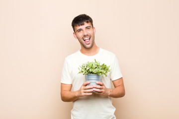 young handsome man with cheerful, carefree, rebellious attitude, joking and sticking tongue out,...