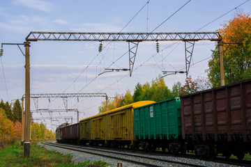 Fototapeta na wymiar Railroad cars loaded with coal. Freight train. Colored wagons on the railway.