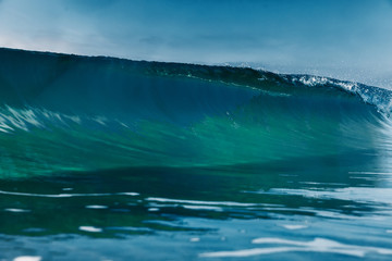 Barrel wave for surfing in ocean. Breaking transparent wave