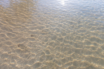 Texture pattern of blue ocean water and bright ripple water and surface transparent and sunlight In the morning. Background sea top view