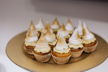 Cakes with cream are served on gold color plate