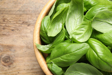 Fresh basil on wooden table, top view