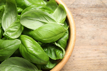 Fresh basil on wooden table, top view