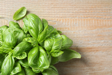Fresh basil on wooden table, top view. Space for text