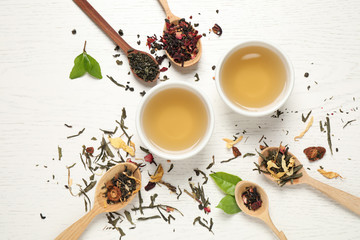 Flat lay composition with green tea on white wooden table