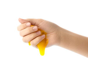 Woman playing with yellow slime isolated on white, closeup. Antistress toy