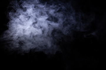 Jet of smoke on black background. Selective focus