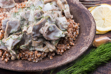 Stewed turkey stomachs with vegetables and buckwheat in a bowl