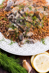 Stewed turkey stomachs with vegetables and buckwheat in a bowl