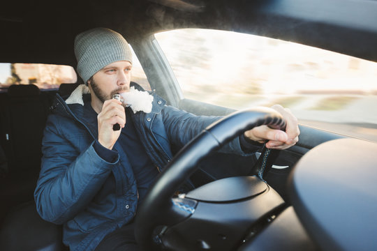 Vaping an electronic cigarette whilst driving in car