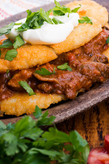 Potato pancakes with meat, vegetable, tomato and parsley