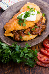 Potato pancakes with meat, vegetable, tomato and parsley