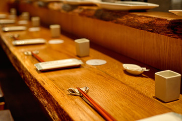 Large wooden table with tableware in Asian style restaurant.