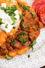 Potato pancakes with meat, vegetable, tomato and parsley
