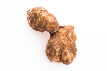 Raw Whole ans sliced Jerusalem artichokes on a white background