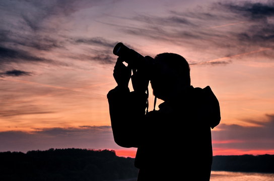 Silhouette of photographer taking picture during sunset .Silhouette of man photographer in sunset.