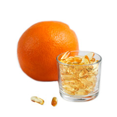 Jelly pills with vitamins, a remedy for cellulite, a means for weight loss. Orange in the background.