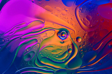 colorful gradient background of oil drops on water surface