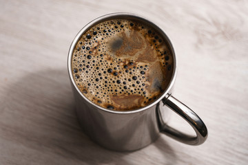Centered metallic cup of instant coffee