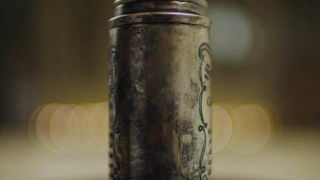 Antique spices jars rotating in slow motion. Cinnamon spices bottle rolling in 360 degree. 