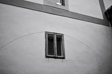 Isolated wooden window in a grey wall (Prague, Czech Republic, Europe)