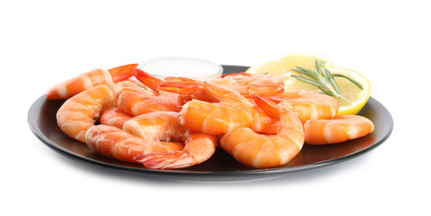 Delicious cooked shrimps served with lemon, salt and rosemary on white background