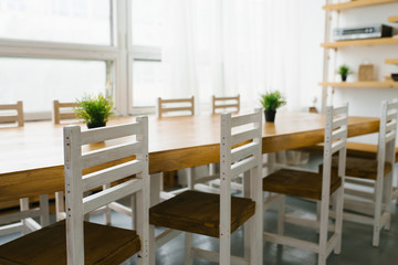 white chairs with a brown seat in the kitchen or dining room in Scandinavian style