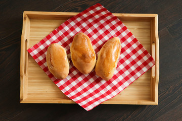 homemade cake on a napkin and a wooden tray