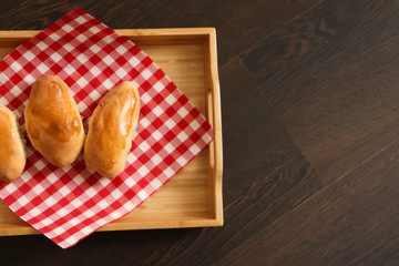 homemade cake on a napkin and a wooden tray