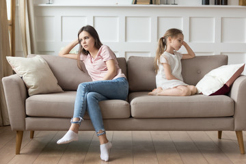 Obraz premium Unhappy mother and stubborn preschool daughter after quarrel